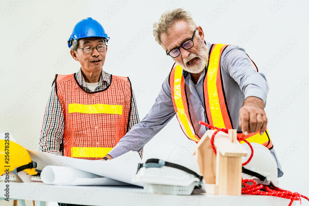 Senior engineers and architect working with construction plan. House building concept.