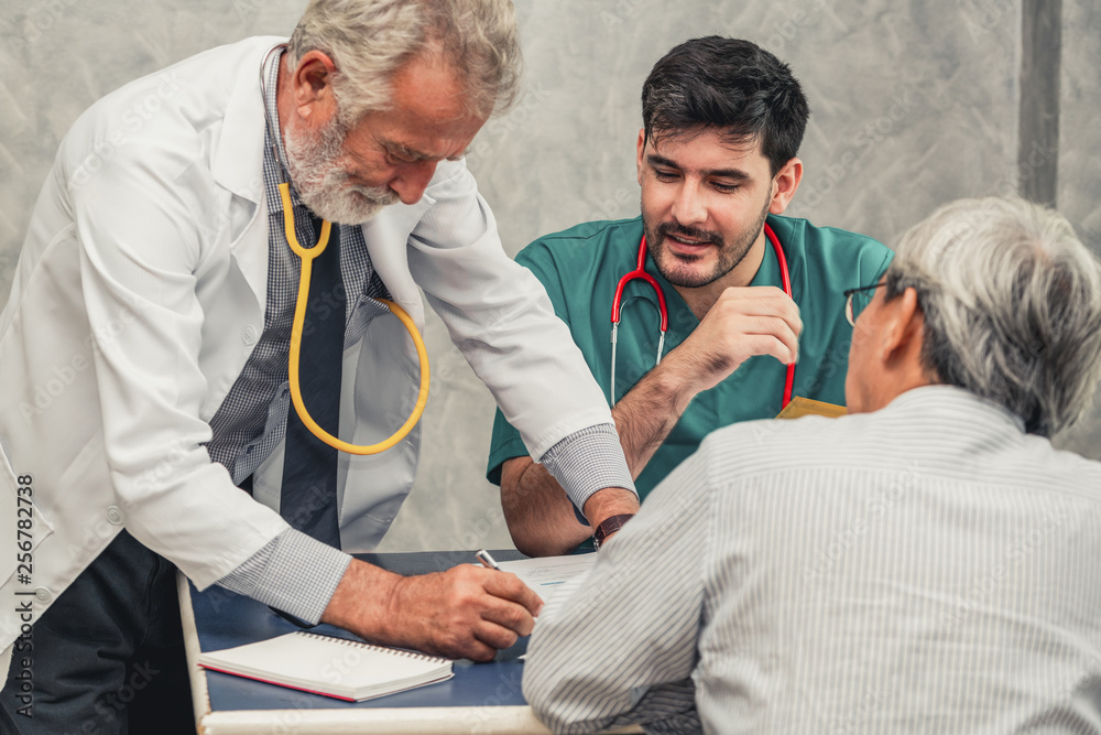 Male doctor team talking to senior patient visit at the hospital office. Medical healthcare staff se