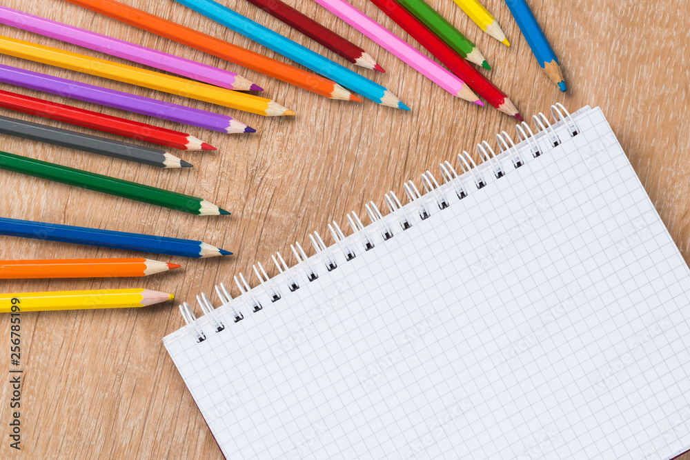 Idea of school still life with pencils and notebook on desk