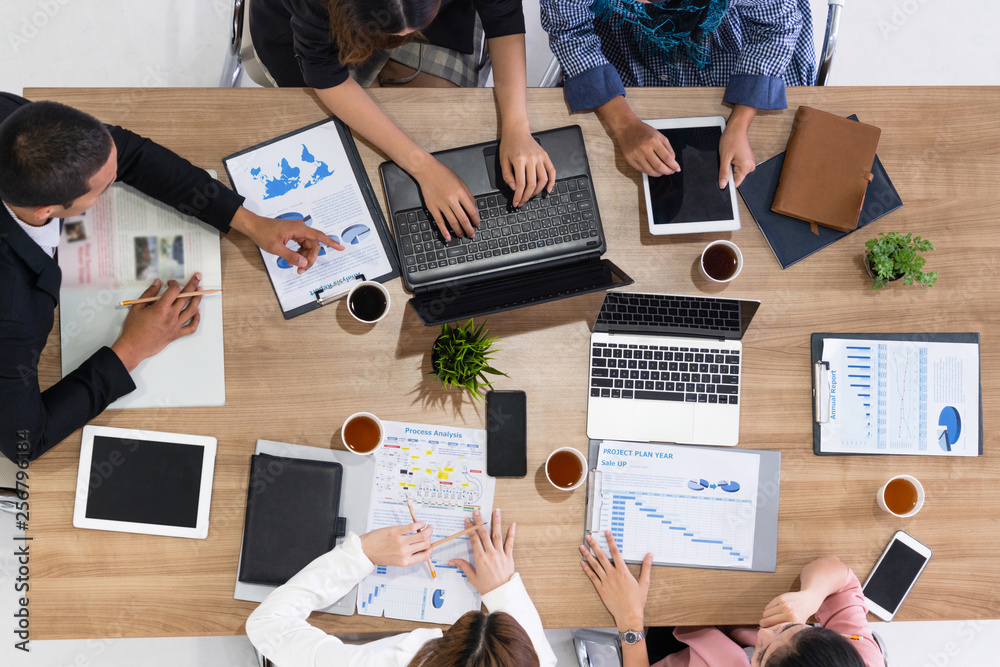 Top view of businessman executive in group meeting with other businessmen and businesswomen in moder