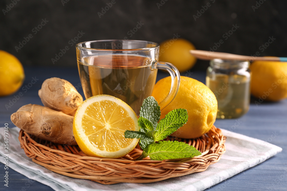 Cup of hot tea with lemon and ginger on table