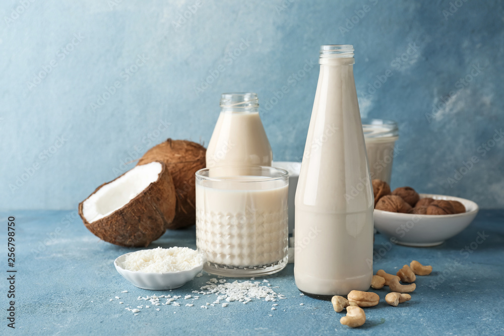 Assortment of tasty vegan milk on color background