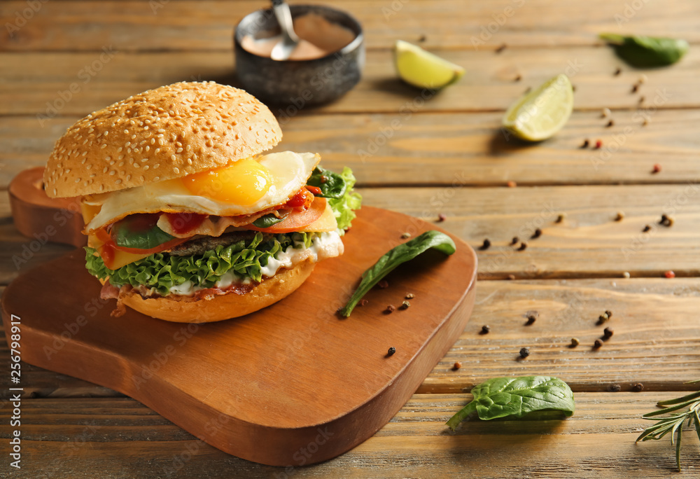 Tasty burger on wooden board