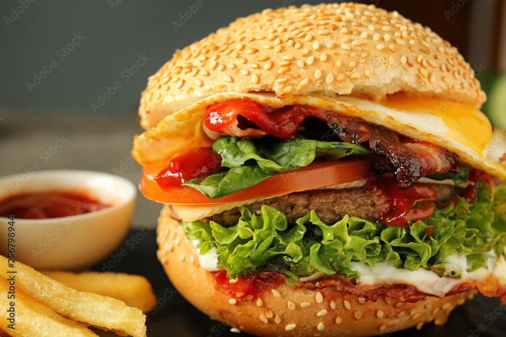 Tasty burger with french fries, closeup