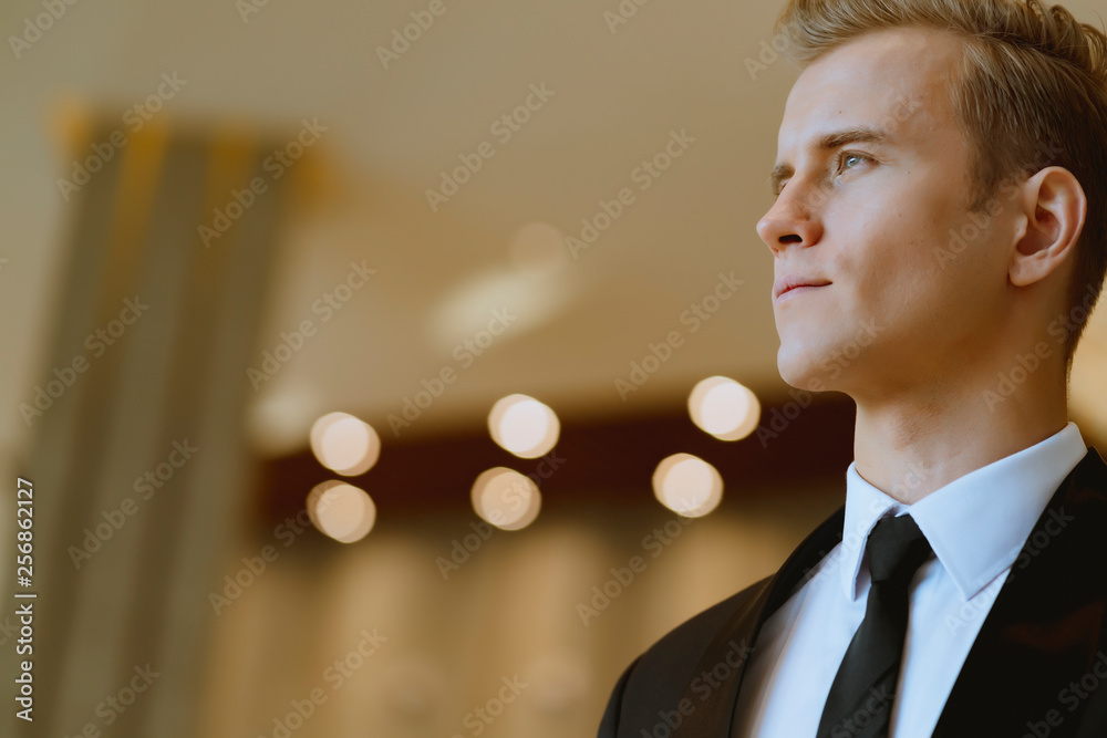 close up business caucasian man in black suit office background