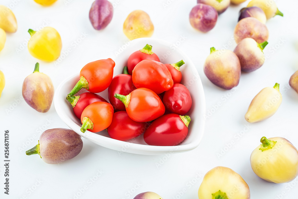 Fresh colorful peppers on white background