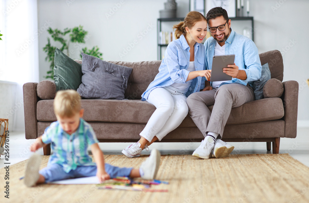 happy family mother father and child son  draw together at home  .