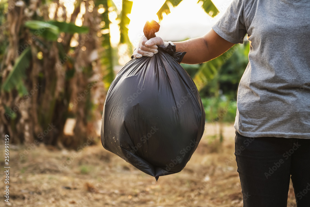 woman hand holding garbage bag for recycle cleaning