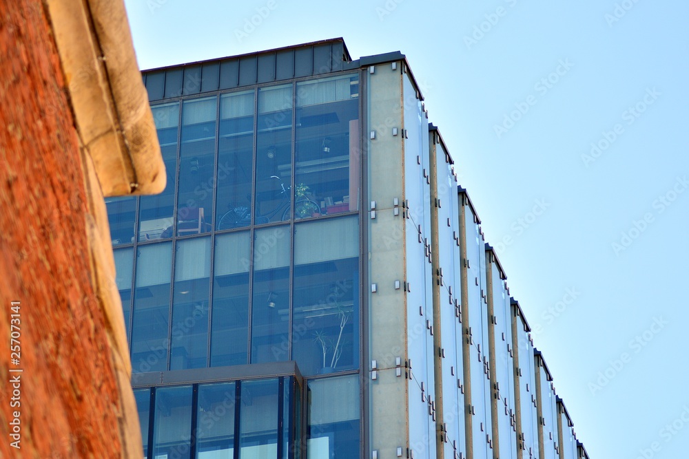 Old brick building in city on background of the modern office center