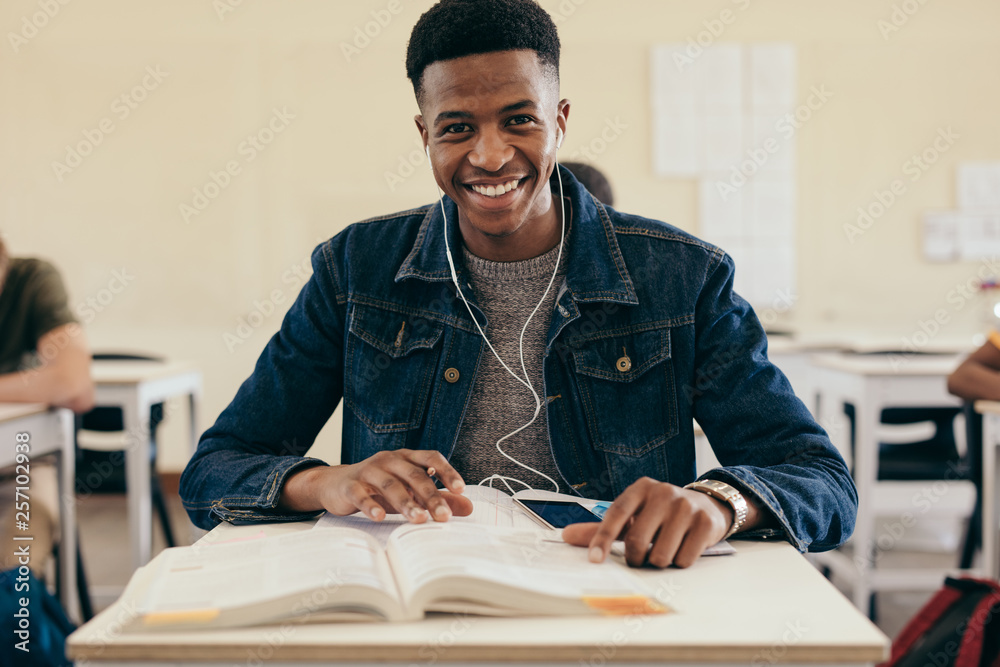 Smiling male student in university classroom