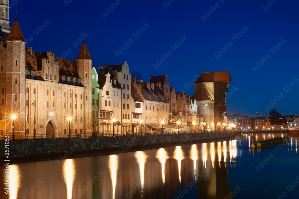 Old town in Gdansk, Poland at night. Riverside with the famous Crane and city reflections in the Mot