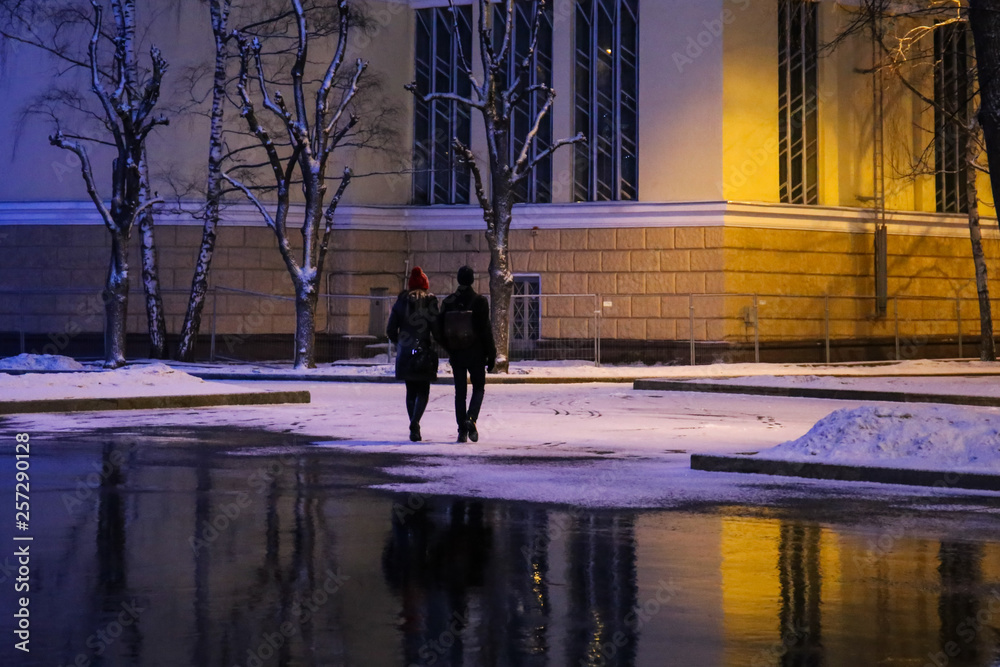 people walking in the city at night