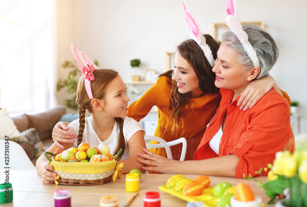 happy Easter! family grandmother, mother and child paint eggs and prepare for holiday.