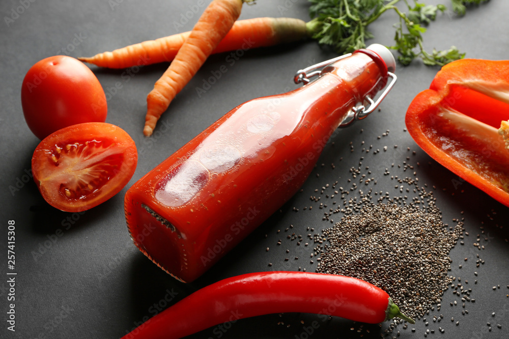 Bottle of healthy smoothie and vegetables on dark background