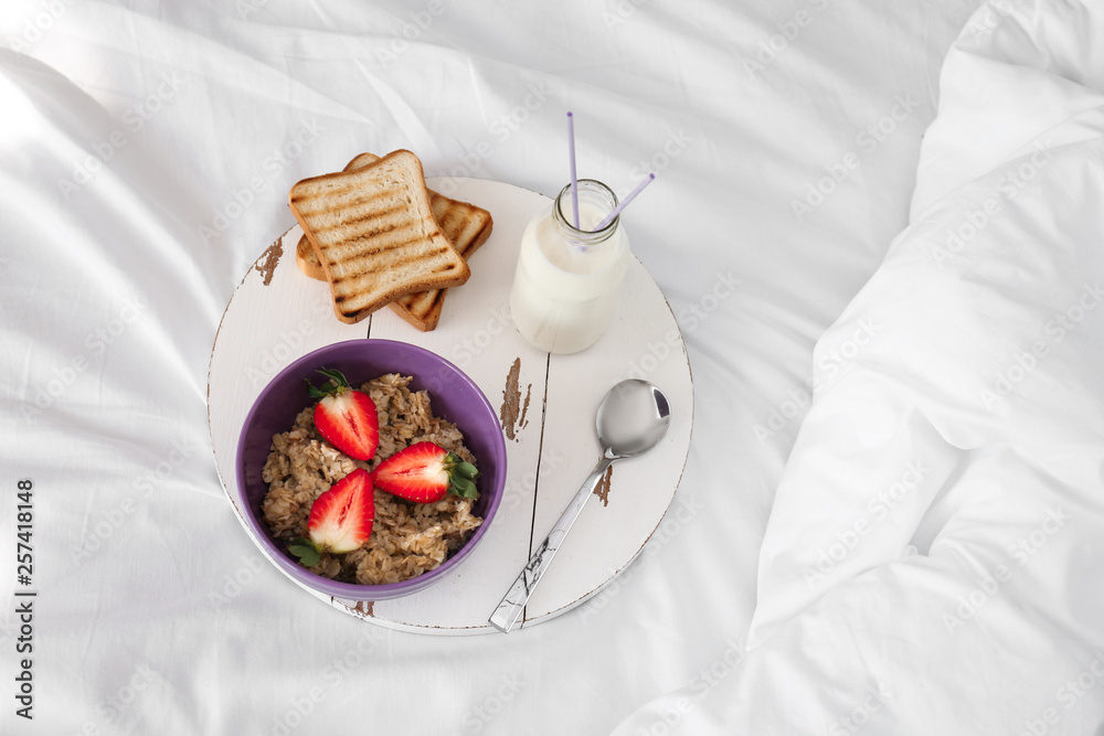 Tasty healthy breakfast on bed