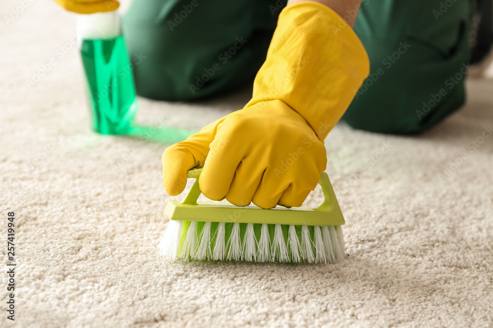 Worker cleaning carpet, closeup