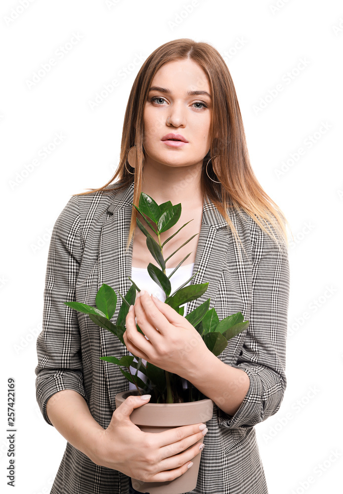 Portrait of beautiful woman with green tropical plant on white background