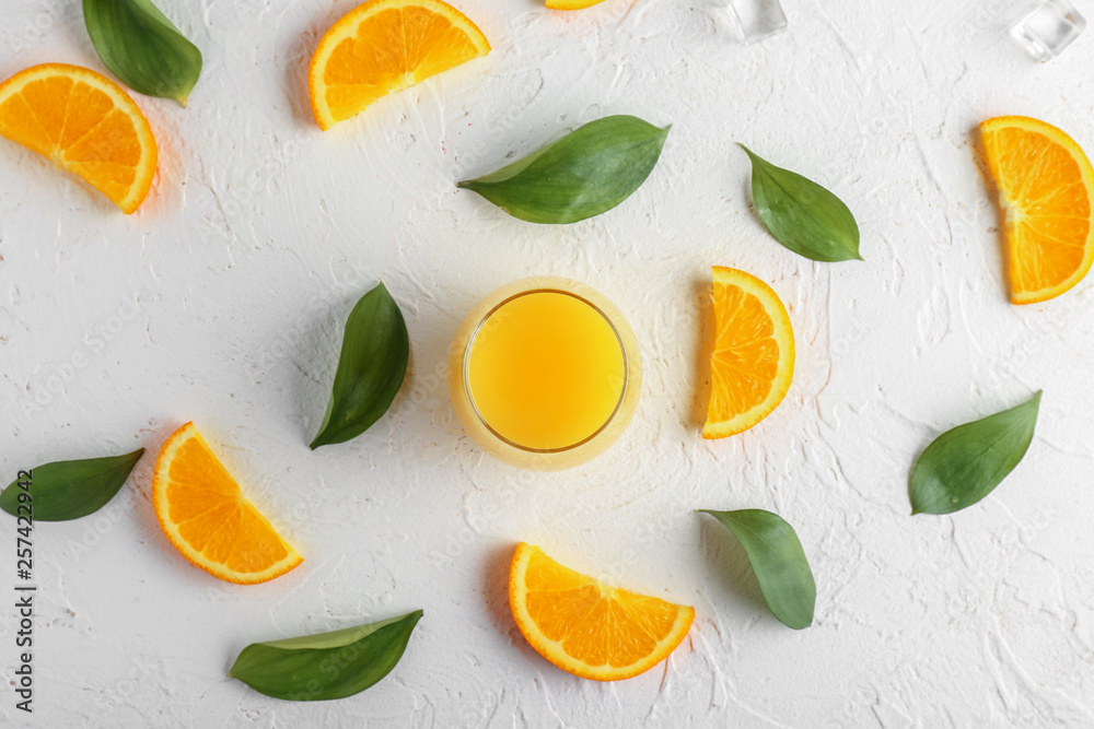 Composition with cut oranges and glass of juice on white background