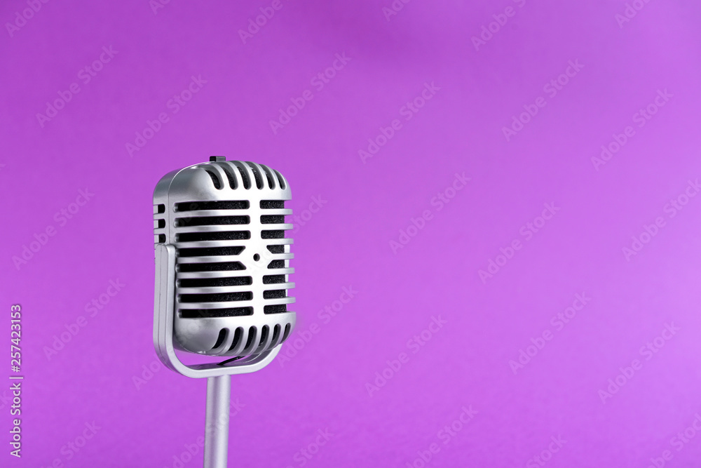 Retro microphone on color background