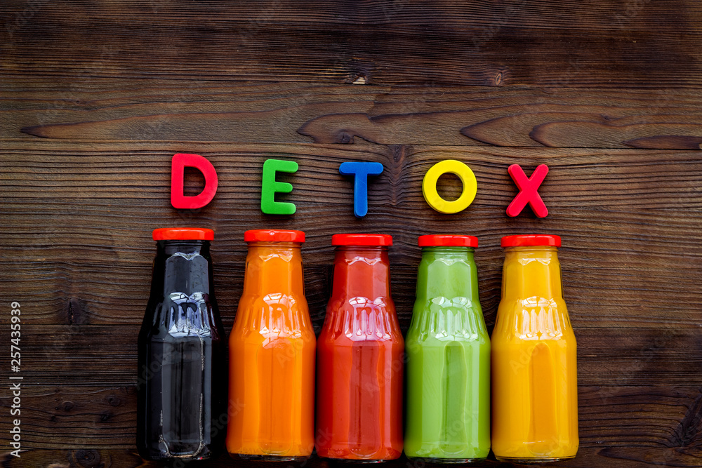 vegetable and fruit juice in bottles for detox drink on wooden background top view mock up