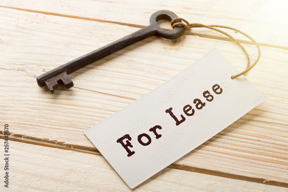 real estate lease concept - old key with tag