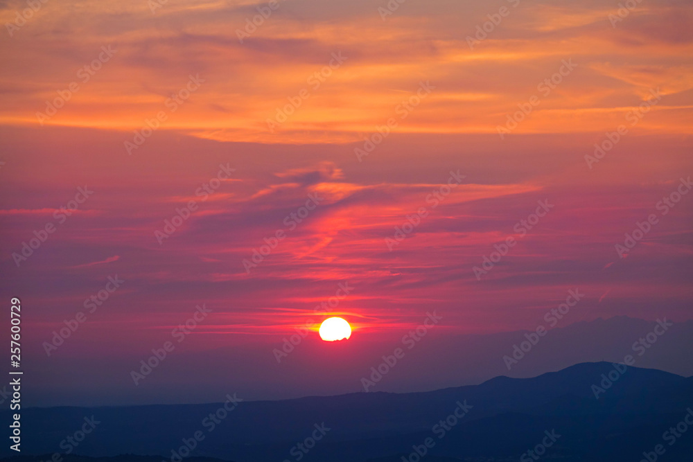 Breathtaking shot of the colorful evening sky illuminated by the golden sun.