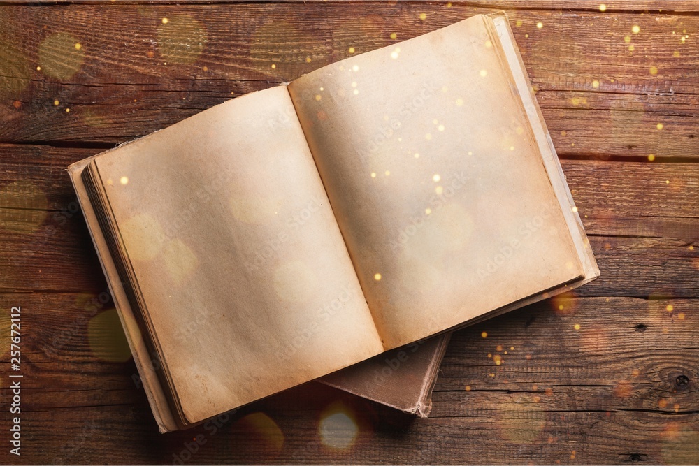 Open book on old wooden table