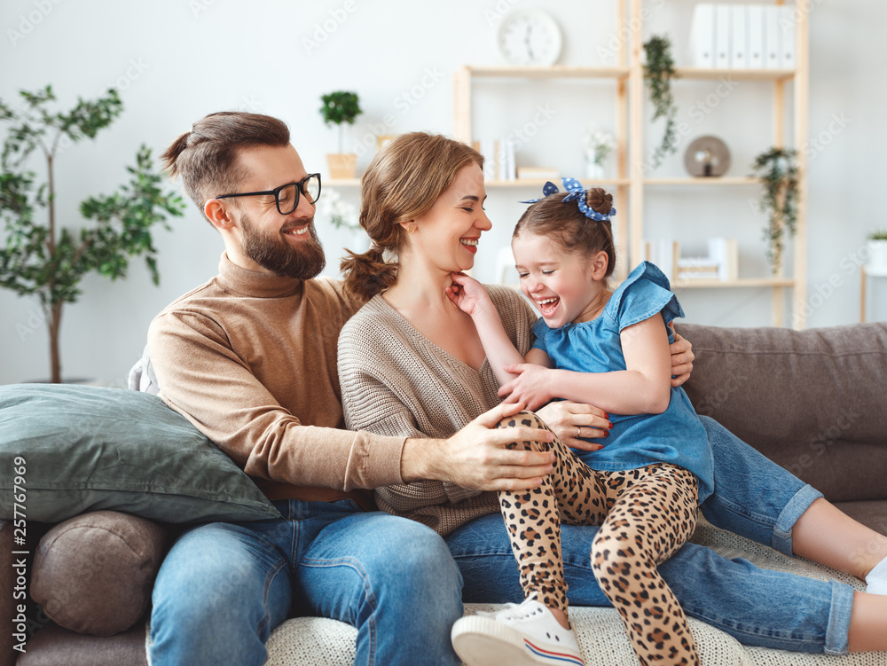 happy family mother father and child daughter laughing   at home  .