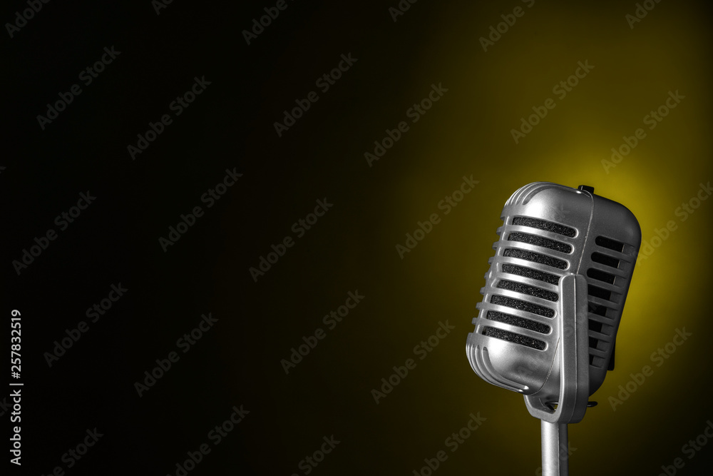 Retro microphone on dark color background