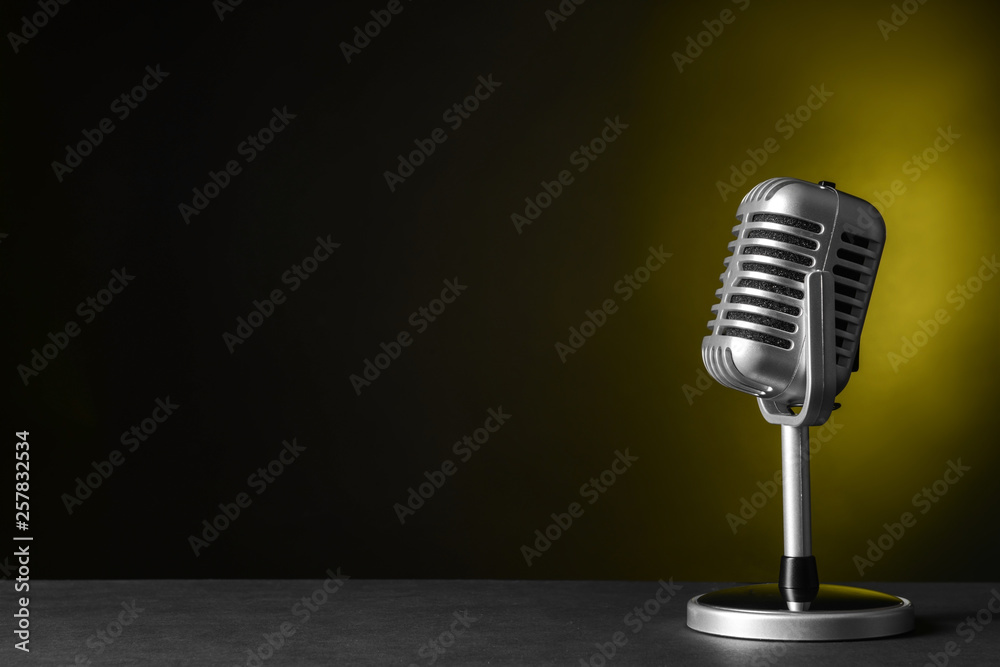 Retro microphone on dark color background