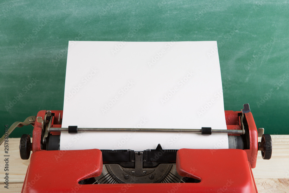 vintage typewriter on the table with blank paper - concept for writing, journalism, blogging