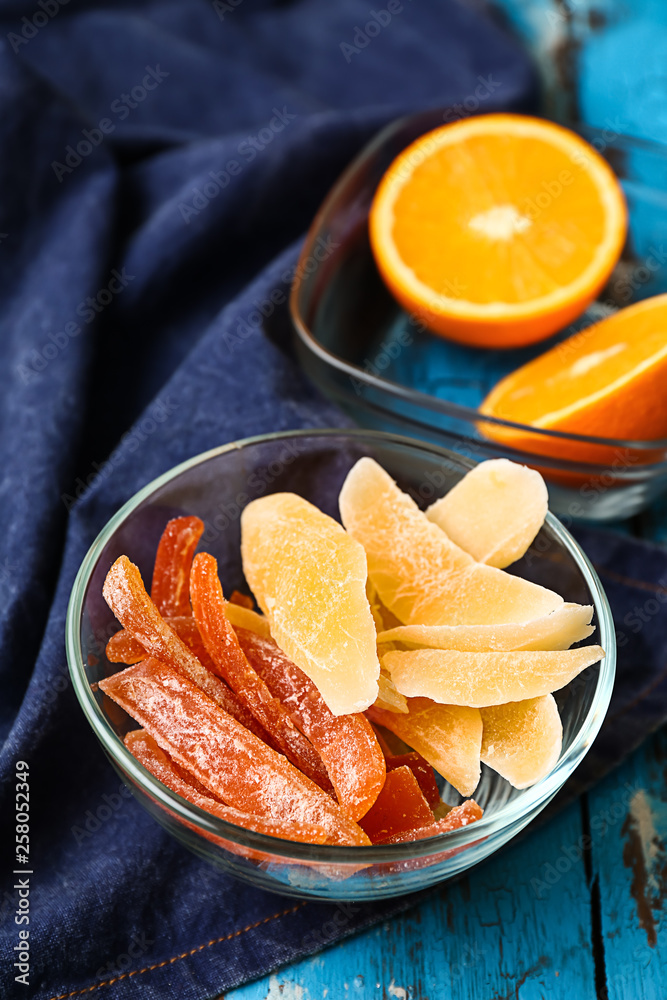 Bowl with tasty dried fruits on table