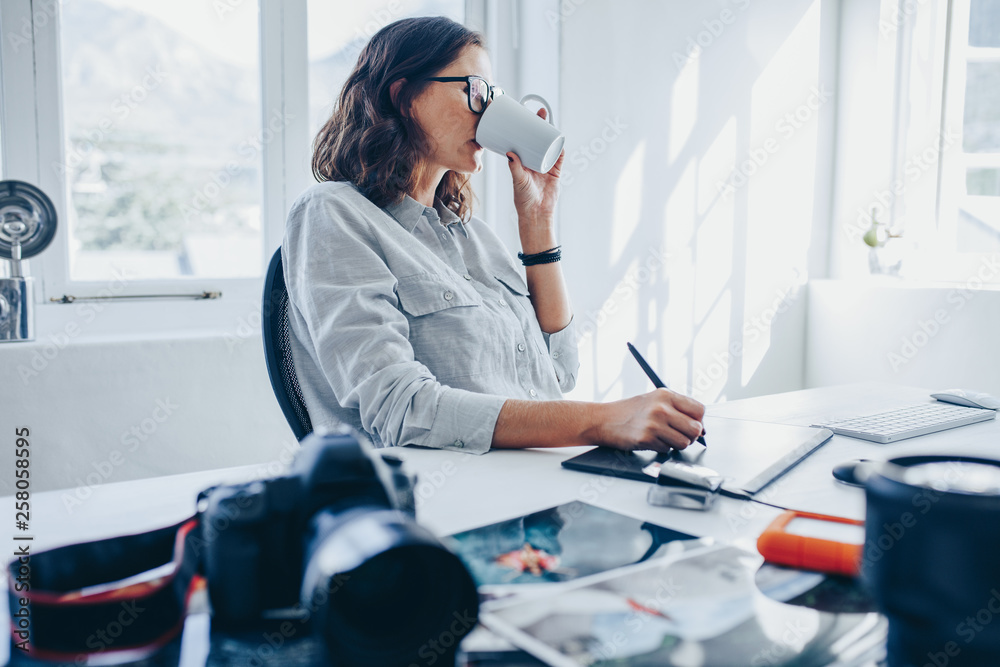 Woman editing images in office