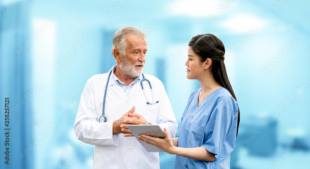 Senior doctor working with young doctor in the hospital. Medical healthcare staff and doctor service