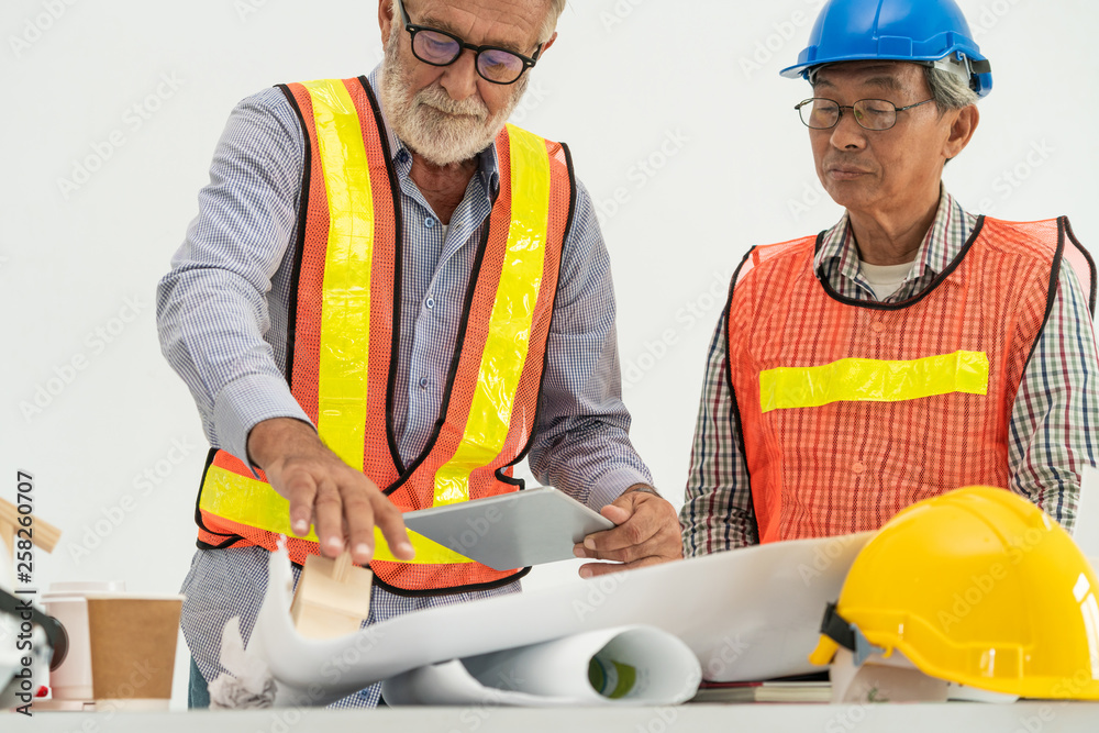 Senior engineers and architect working with construction plan. House building concept.