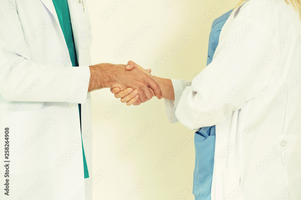 GP doctor shake hand with surgical doctor on white background.