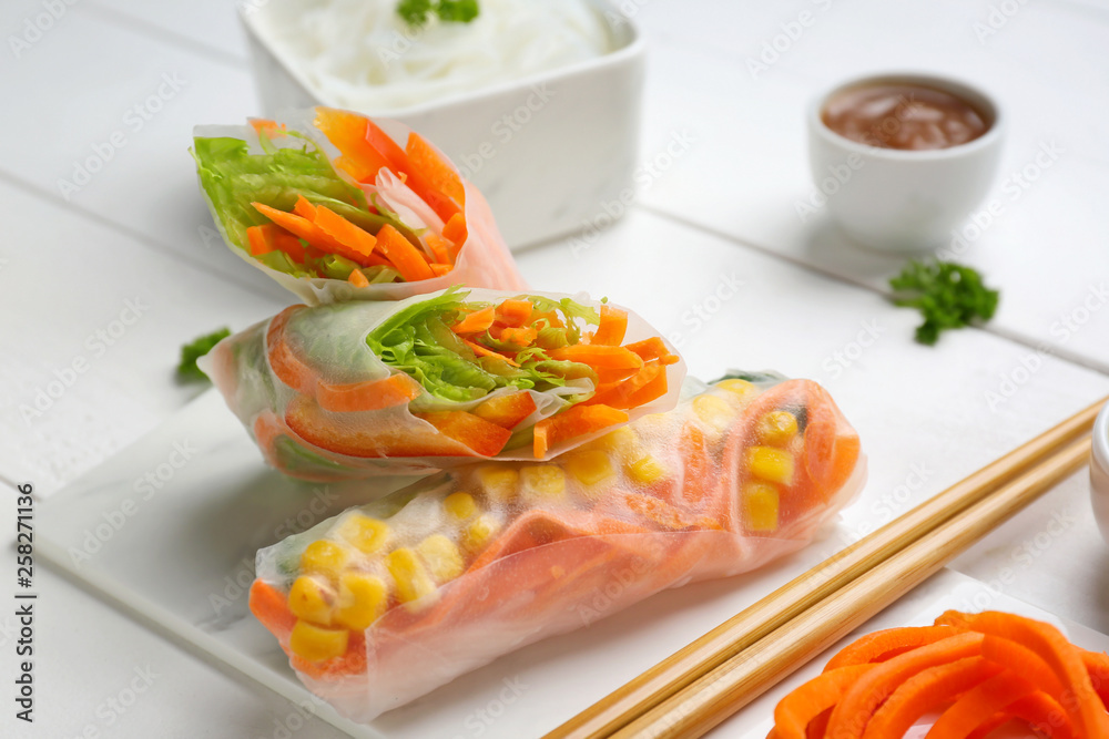 Tasty spring rolls on white table