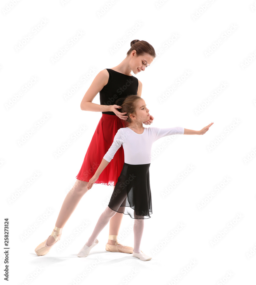 Little ballerina training with coach against white background