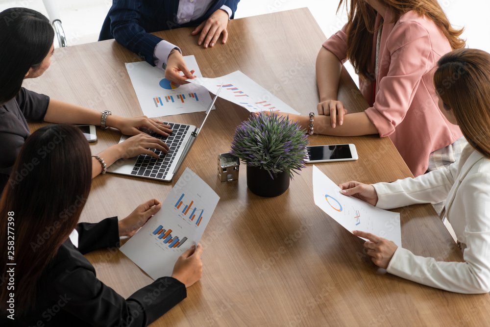 Businesswoman in group meeting discussion with other businesswomen colleagues in modern workplace of