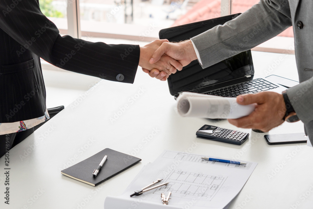 Businessman executive handshake with businesswoman worker in modern workplace office. People corpora