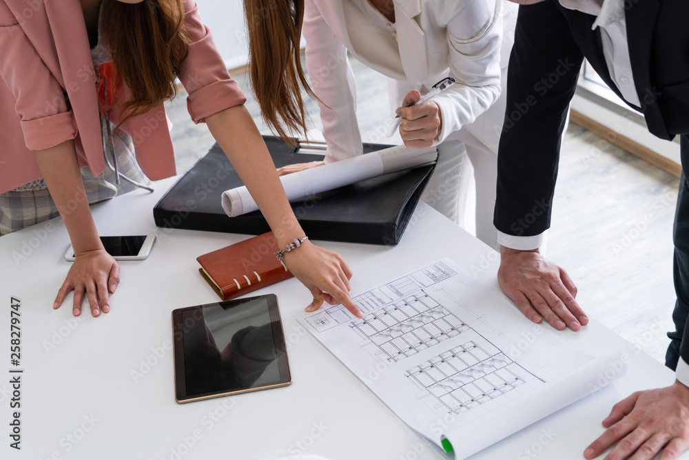 Architect and engineer working with construction drawing project on table in office. Architecture an