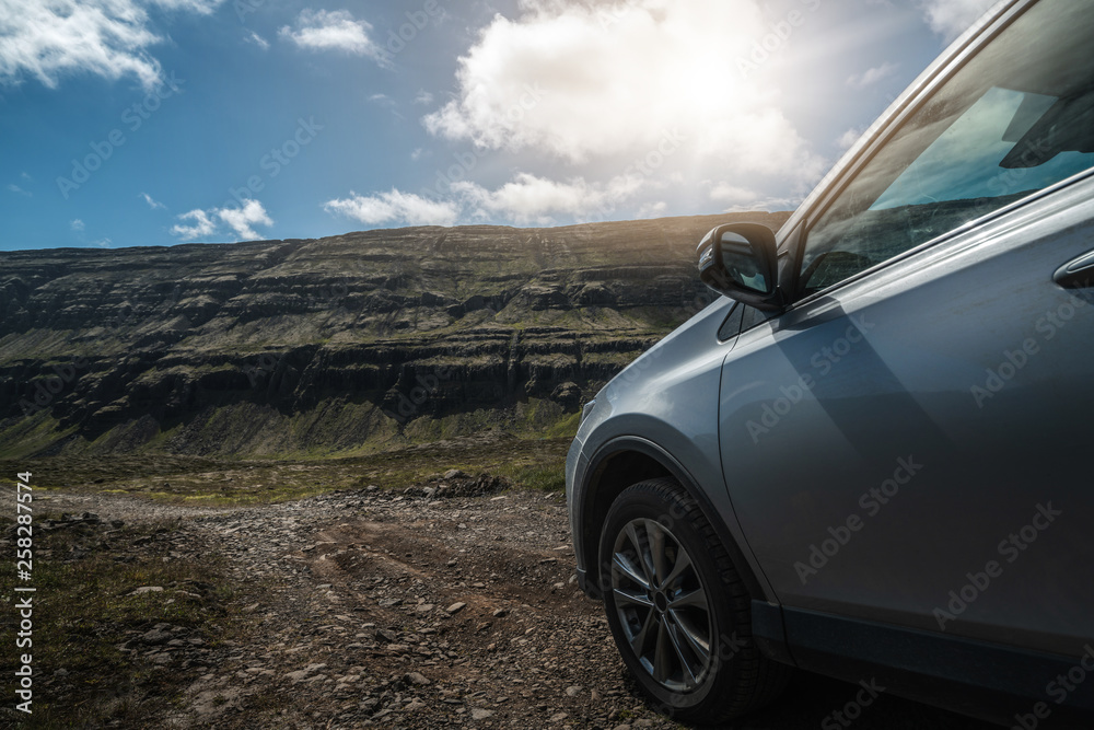 4WD SUV vehicle car running on gravel road with nature mountain landscape in Iceland. Adventure and 