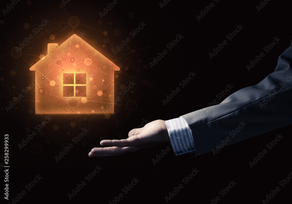 Conceptual image with hand pointing at house or main page icon on dark background