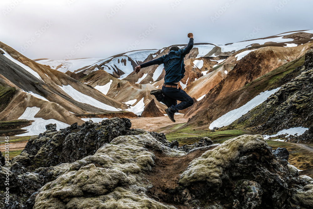 Traveler hiking at Landmannalaugar surreal nature landscape in highland of Iceland, Nordic, Europe. 