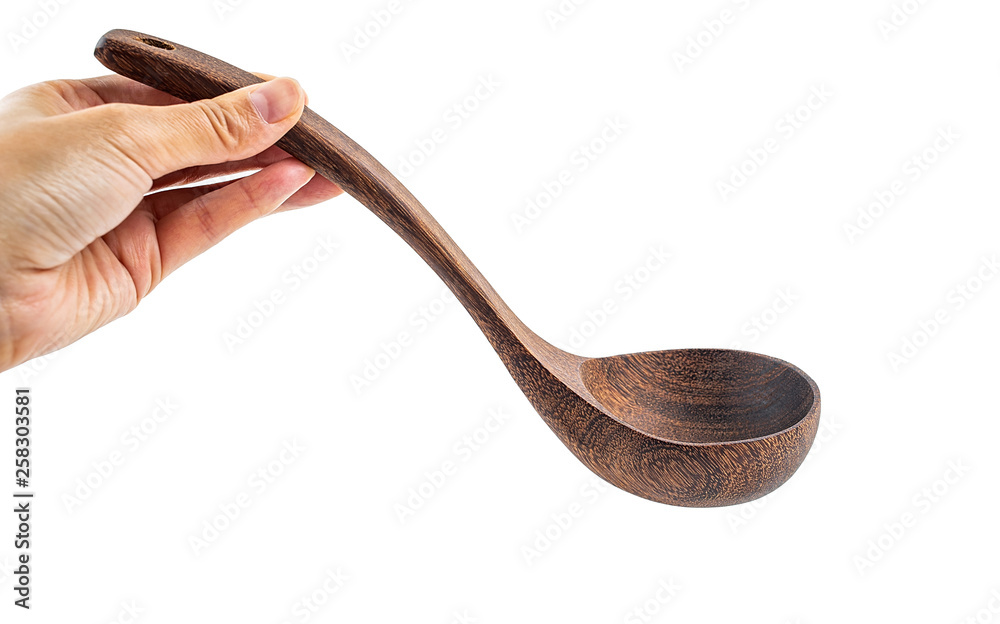 Hand holding empty wooden soup spoon on white background