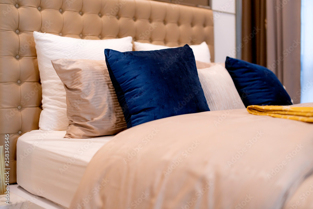 Bed maid-up with clean white pillows and bed sheets in beauty bedroom. Close-up. interior background