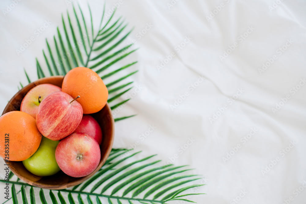 fresh fruit on wooden bowl on white bed morning healthy lifestyle