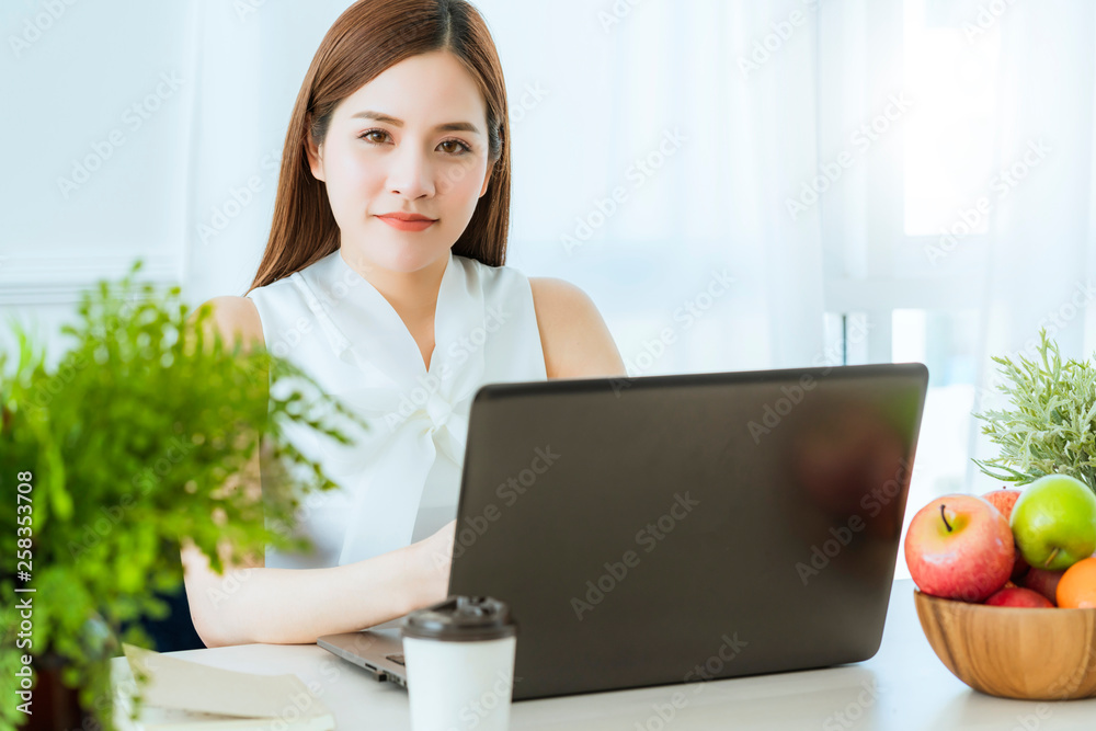 smart executive asian woman white dress meeting with coworker with laptop presentation office backgr