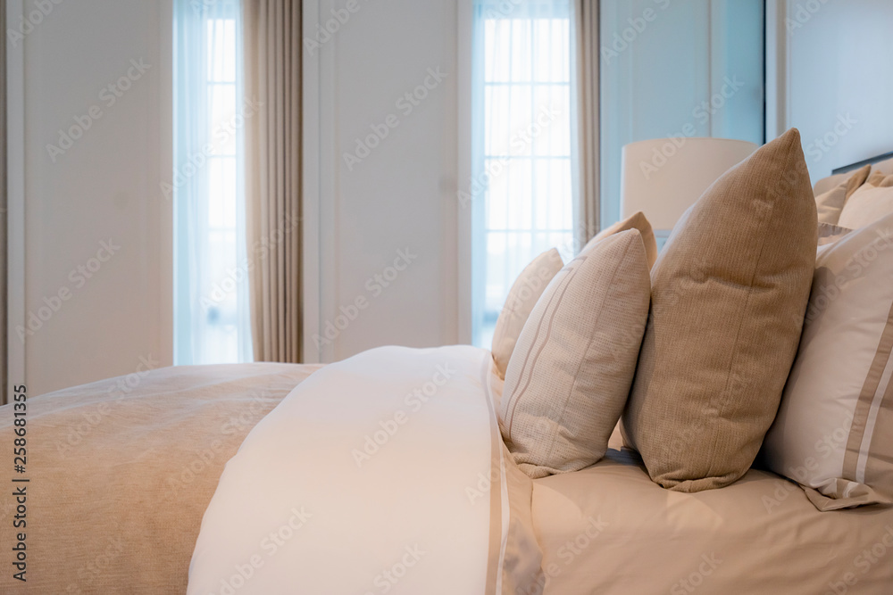 Bed maid-up with clean white pillows and bed sheets in beauty bedroom. Close-up. interior background