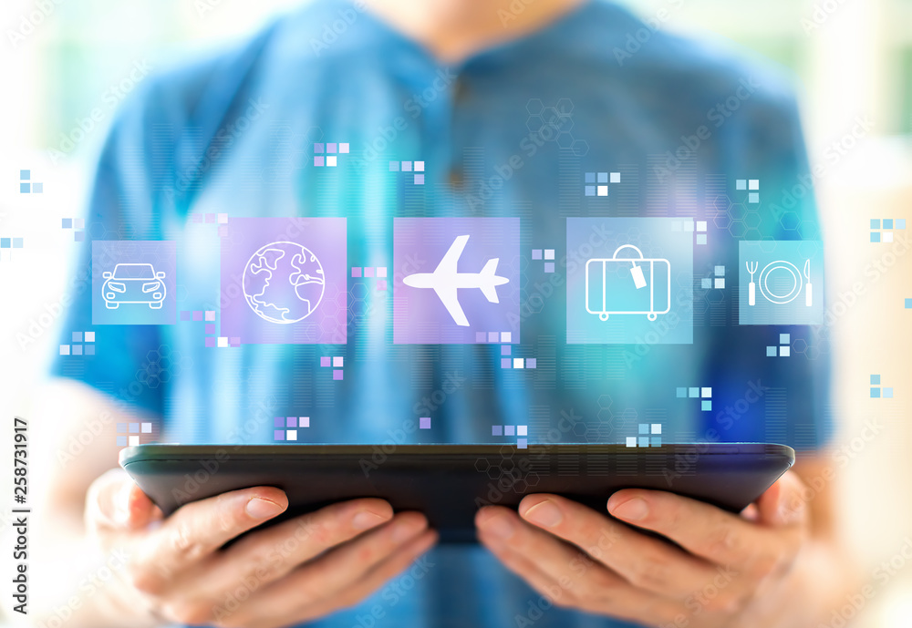 Airplane travel theme with young man using a tablet computer